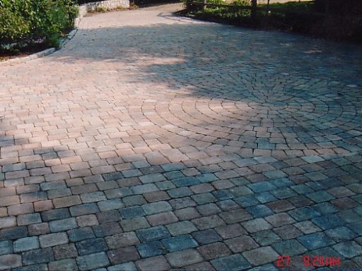 Red stone block driveway with circular feature